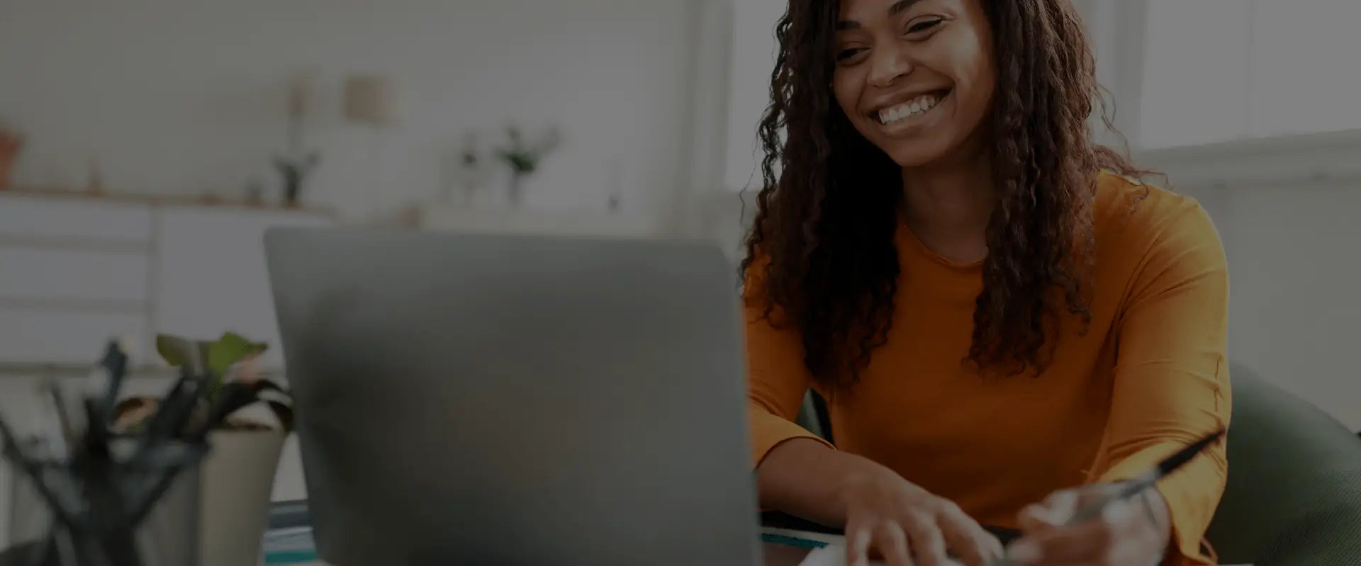 Woman smiling at her laptop