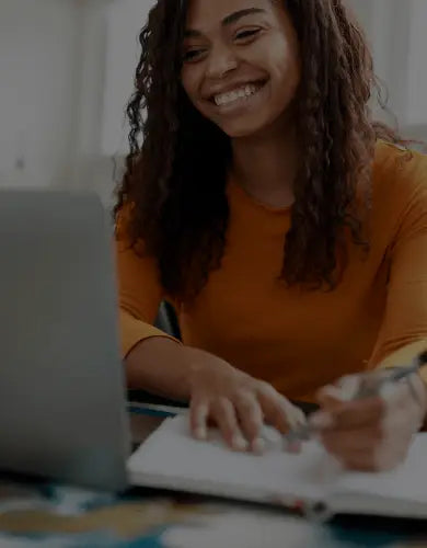Woman smiling at her laptop